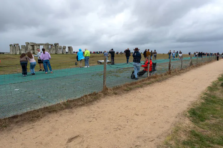 The free footpath at Stonehenge is separated from the ticketed area by a low fence