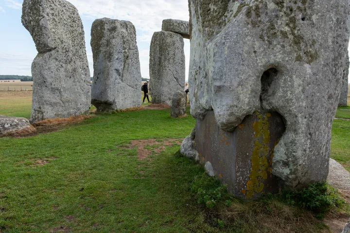 A large concrete block at the base of one of the stones