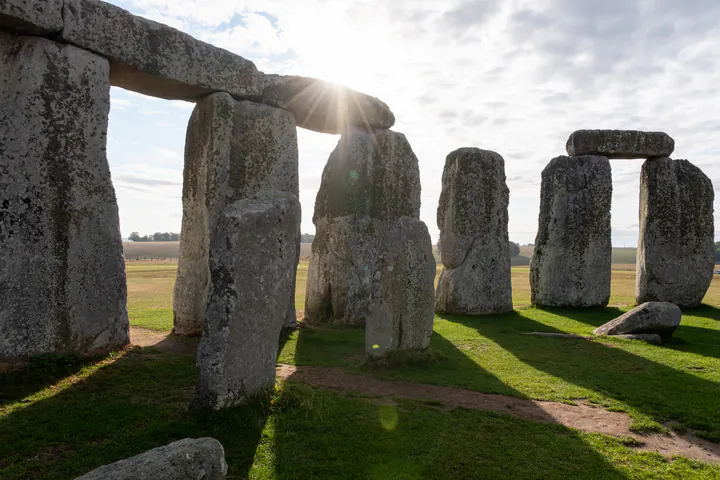 Inside the stone circle at Stonehenge. It's early morning so the stones are casting long shadows.
