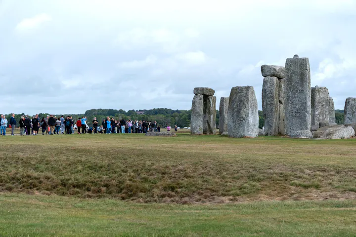 On the path around Stonehenge. There's a crowd of people at the closest point to the stone circle.
