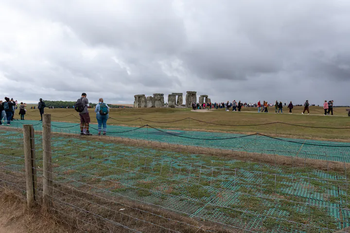 Stonehenge is in the distance and there's a fence in the way, but it's still a great view