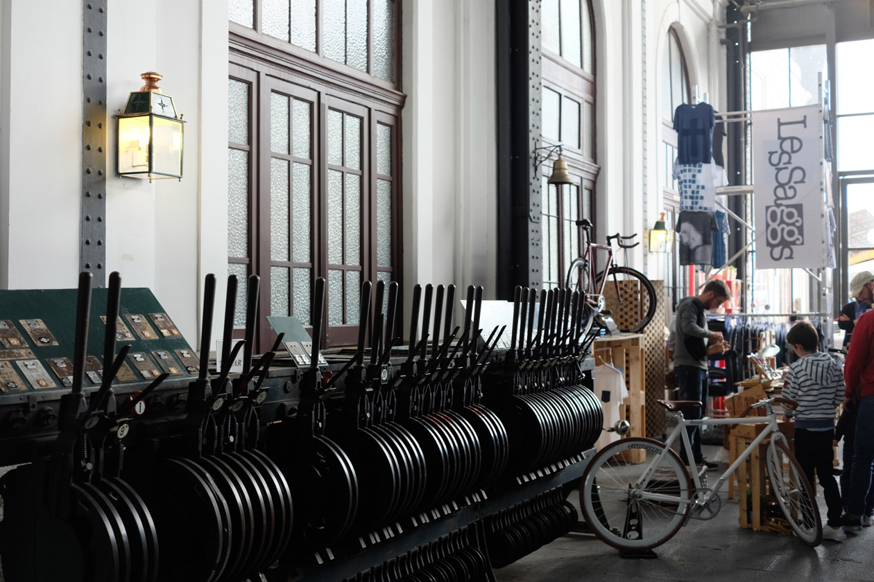 A stall selling quirky bikes beside the old levers of the railway station