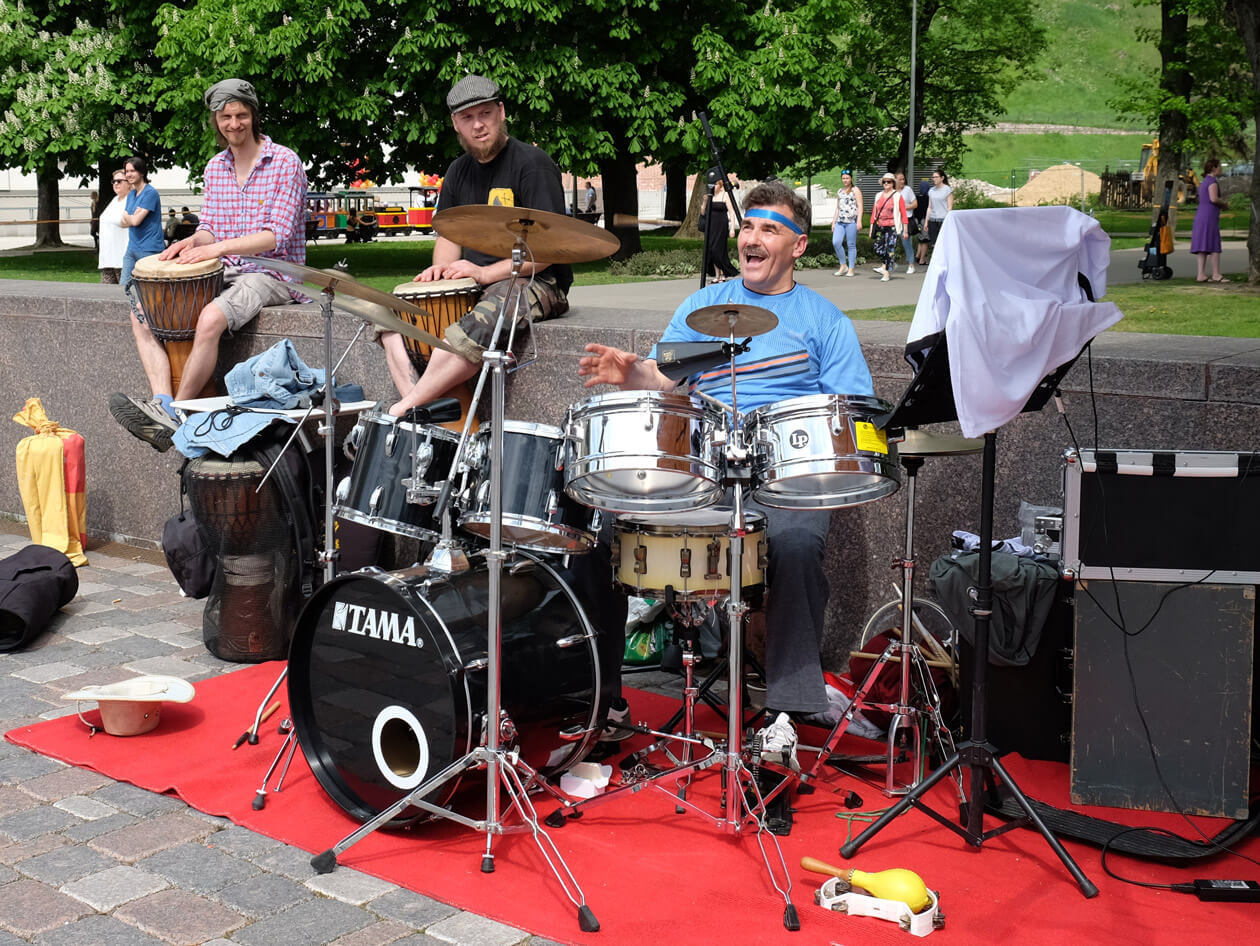 A drummer throwing his drumsticks up in the air on Street Music Day in Vilnius
