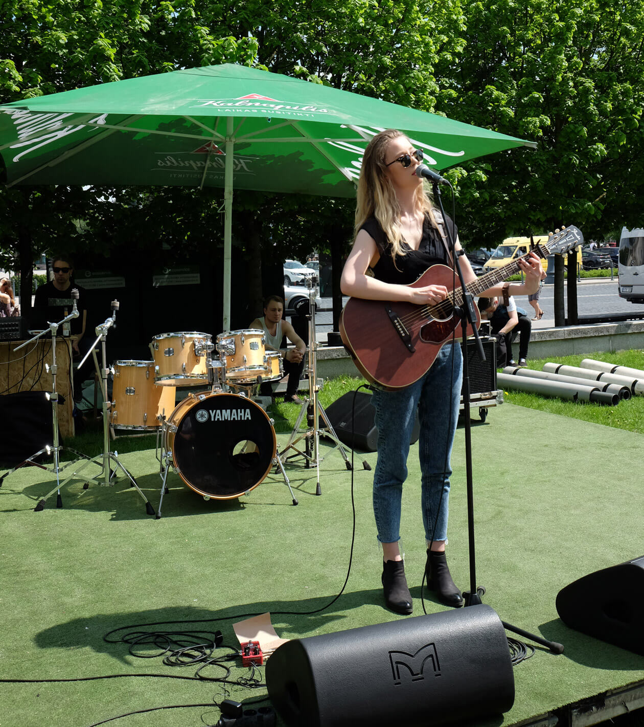 A soloist with her acoustic guitar near the Cathedral