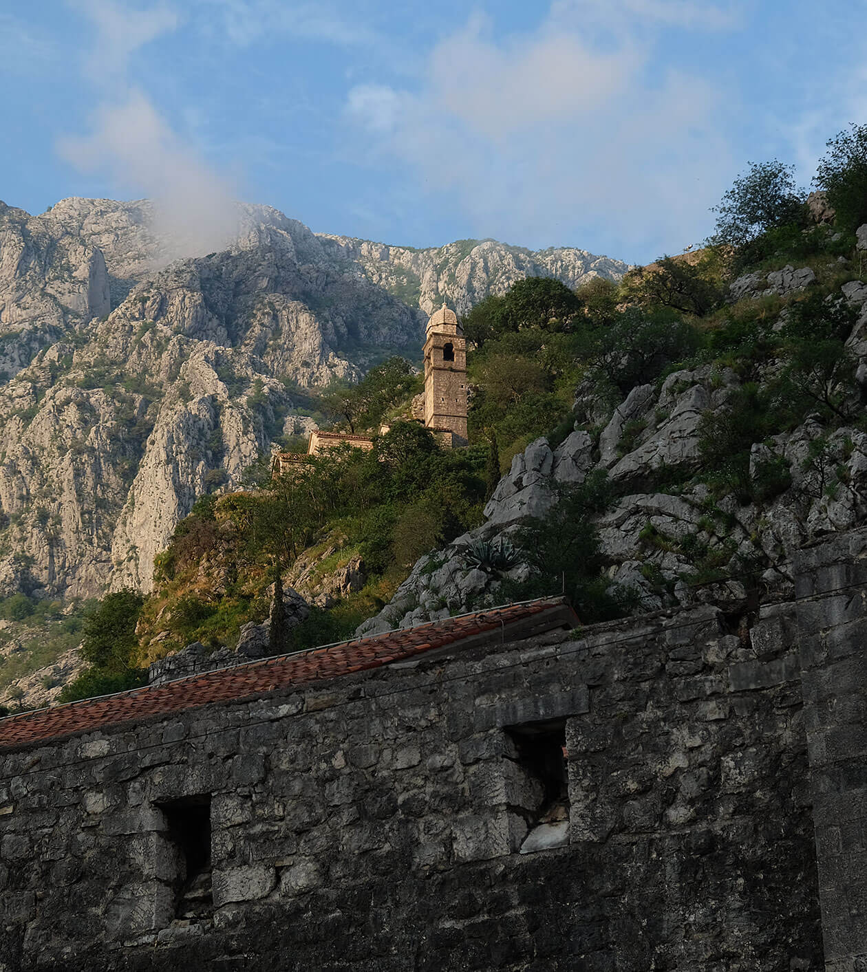 Kotor city walls and church in the evening sunshine