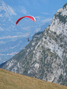 A paraglider launching themselves from the top of Monte Baldo
