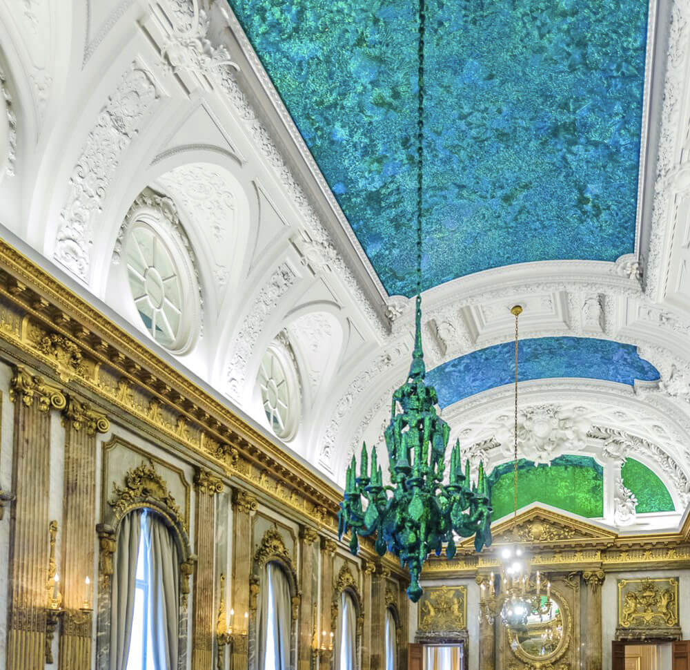 The ceiling and chandeliers in the Royal Palace's Mirror Room are covered in millions of iridescent beetles