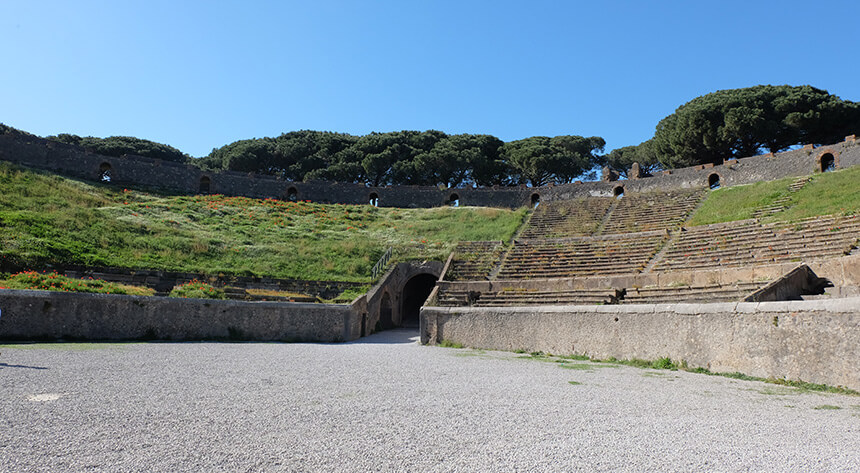 The large amphitheatre at Pompeii is the oldest surviving Roman amphitheatre in the world. It's located at the far end of the site, a mile from the main gate and the Forum.