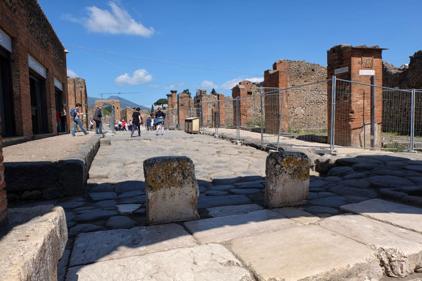 The cafe inside the Pompeii ruins (on the extreme left in this picture) serves drinks, coffee, sandwiches, pizza slices, salads and other snacks. It's located behind the Forum.