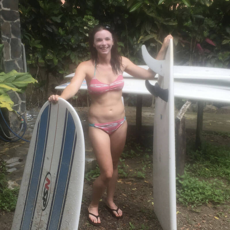 Katie from Just Chasing Sunsets and the surfboard she broke on her 29th birthday