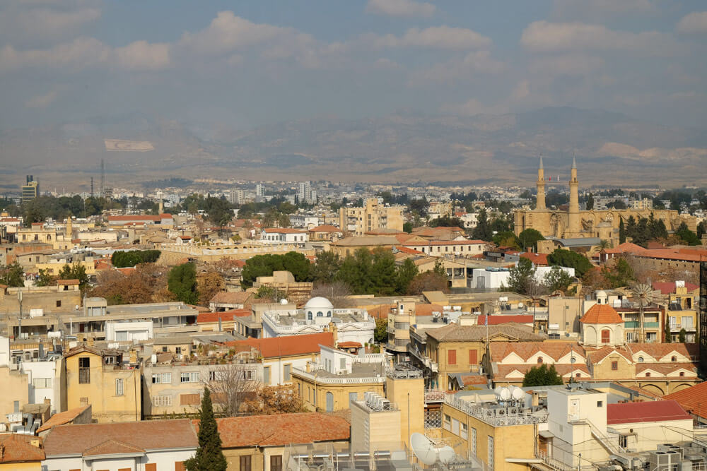 The view across North Nicosia from Shacolas Tower in the south. You can see the North Cyprus flag on the mountainside in the background.