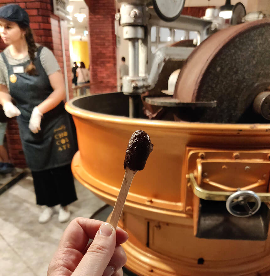 Tasting the ground up cocoa paste while our guide explains what's happening in the machine.