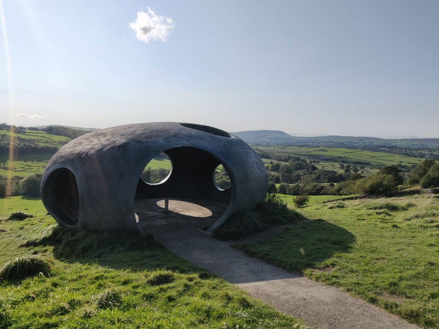 The Atom Panopticon, high on a hill overlooking Wycoller village, with Pendle Hill in the distance