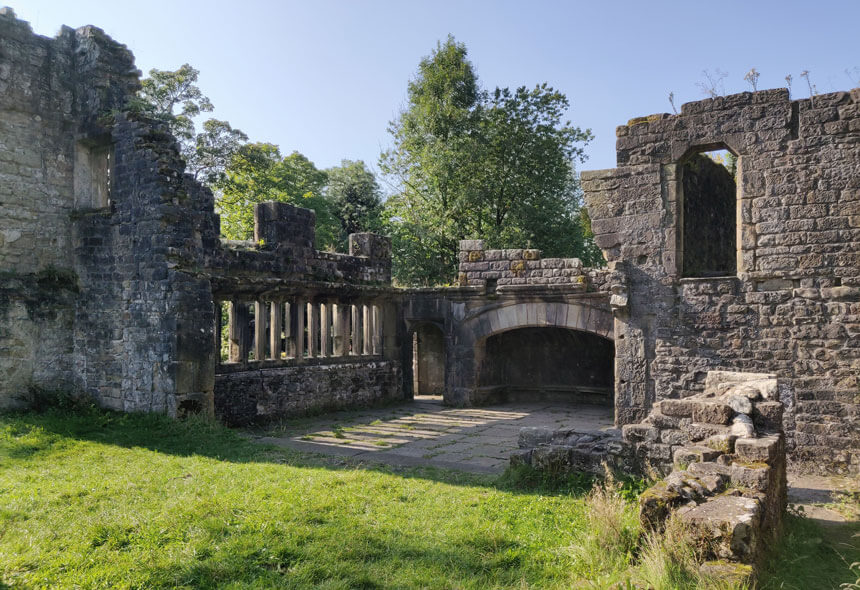 It's free to wander around the ruins of Wycoller Hall. A large room has a partially flagged floor with mullioned windows and an enormous fireplace.