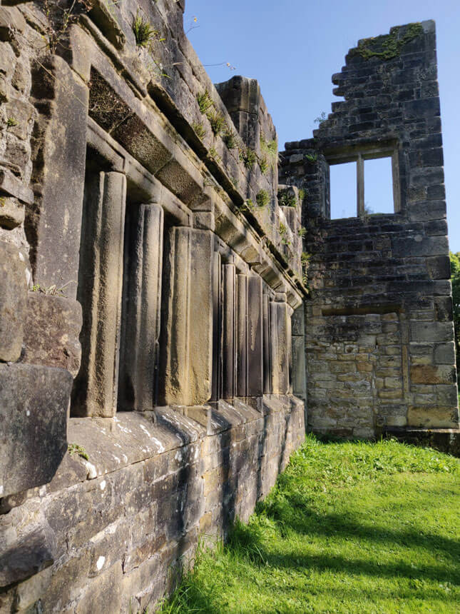 Will you see the ghost of Black Bess when you visit Wycoller? The ruins of an old stone house are silhouetted against a summer sky.