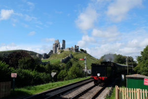 A steam train in the heritage railway station at Corfe Castle, Dorset