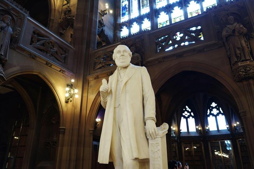 A white marble statue of John Rylands, inside the library that bears his name.