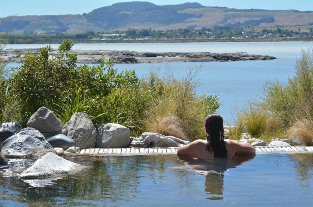 A woman enjoying a thermal bath in Rotorua, New Zealand