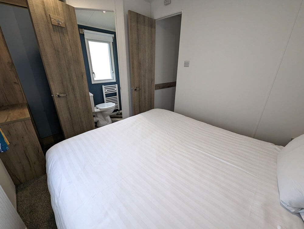 The main bedroom in our New Wave Gold 2 bedroom caravan. This bedroom has a nice big bed and an ensuite toilet and washbasin.