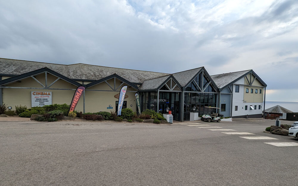 The large main building at Woolacombe Bay Holiday Park. The building holds the reception, swimming pool, cinema, entertainment zone, two bars and a restaurant