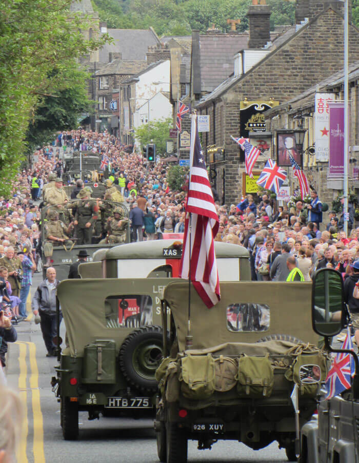 A parade of military vehicles through Uppermill during Yanks Weekend