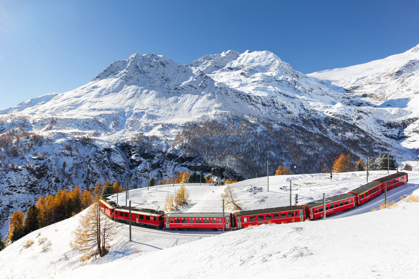 A Bernina red train through the Alps, near Alp Grüm