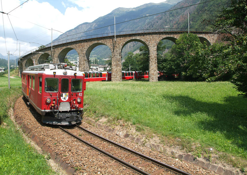A Bernina Express train coming out of the amazing Brusio spiral viaduct
