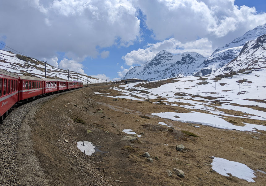 The red train makes its way across the Bernina pass near Bernina Diavolezza station