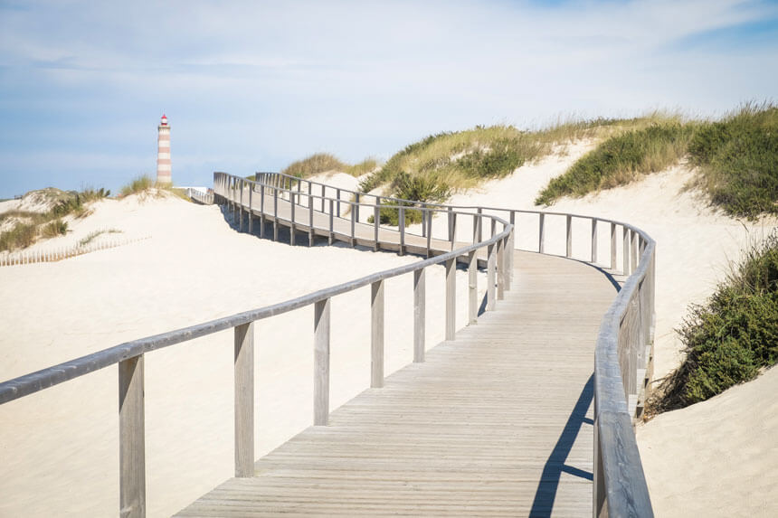 The beach boardwalk near Costa Nova, with the Barra lighthouse in the background