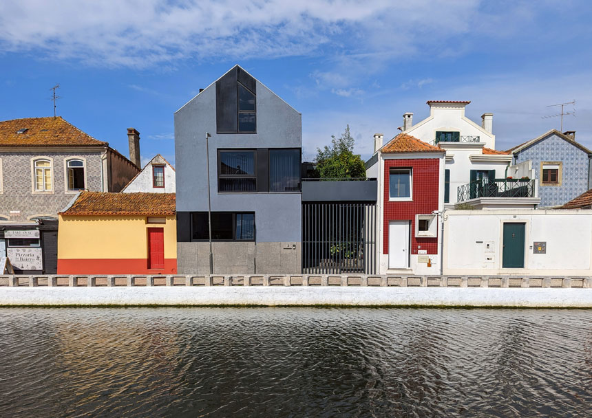 A modern house alongside traditional buildings on one of Aveiro's canals