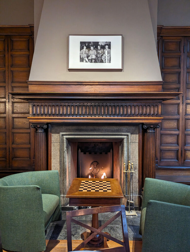 The cosy fire in the Grand Hotel Terminus's Amundsen Bar. The photo on the chimney breast is of Norwegian explorer Roald Amundsen holding his last press conference here in 1928.
