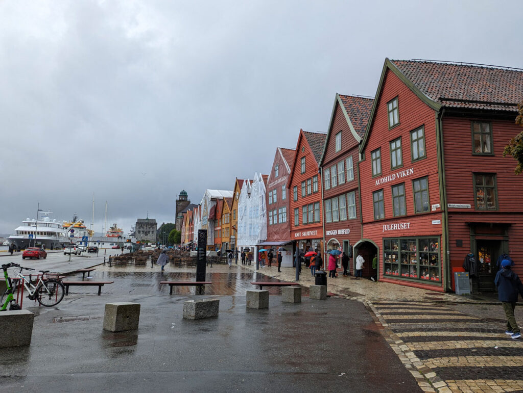 Walking along historic Bryggen in the rain