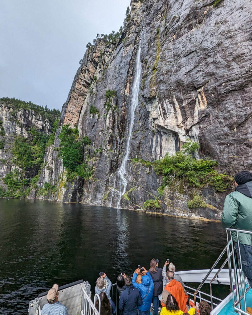 A waterfall down a steep rock face on a fjord cruise from Bergen to Mostraumen