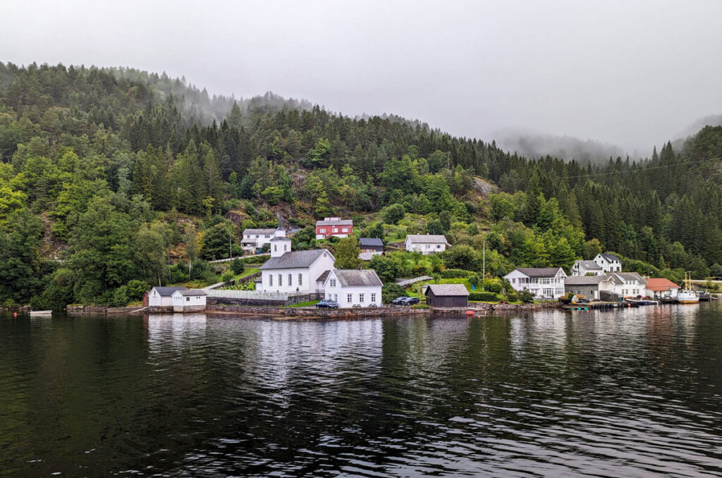 A pretty village with traditional houses, nestled by the side of the fjord