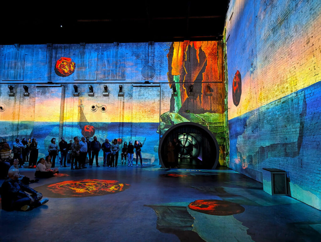 The Dalì immersive exhibition at Fabrique des Lumières. Dali paintings are blown up to an enormous size and projected across the walls of an old gas factory.