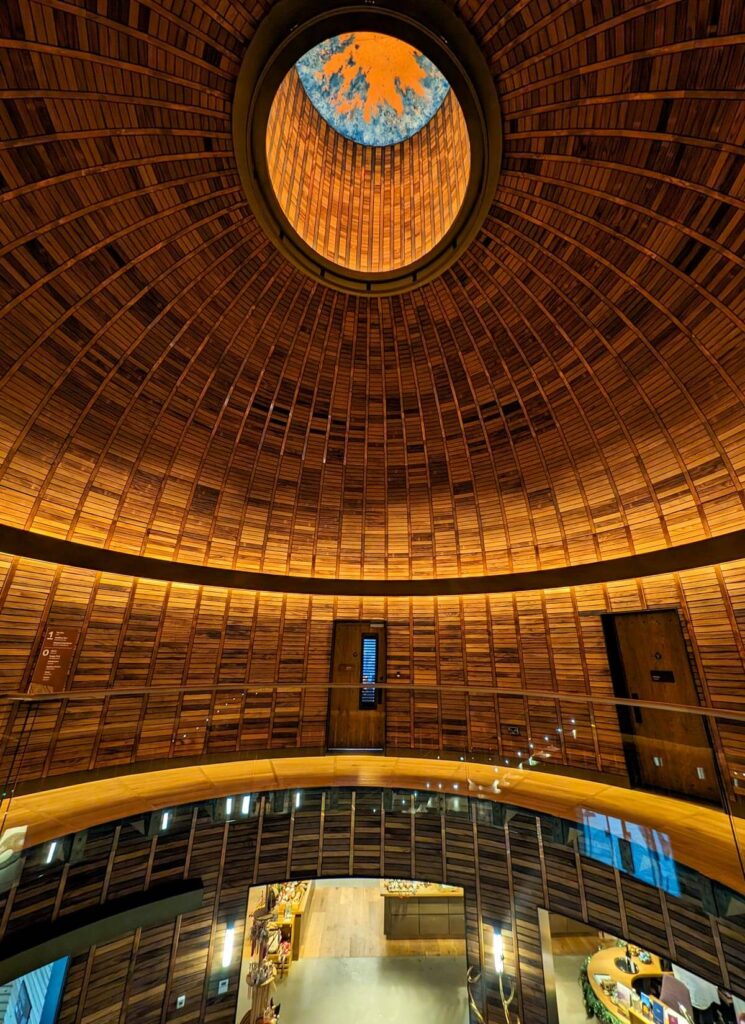 The beautiful wooden entrance hall at Ad Gefrin makes you feel as if you're inside a giant whisky barrel.