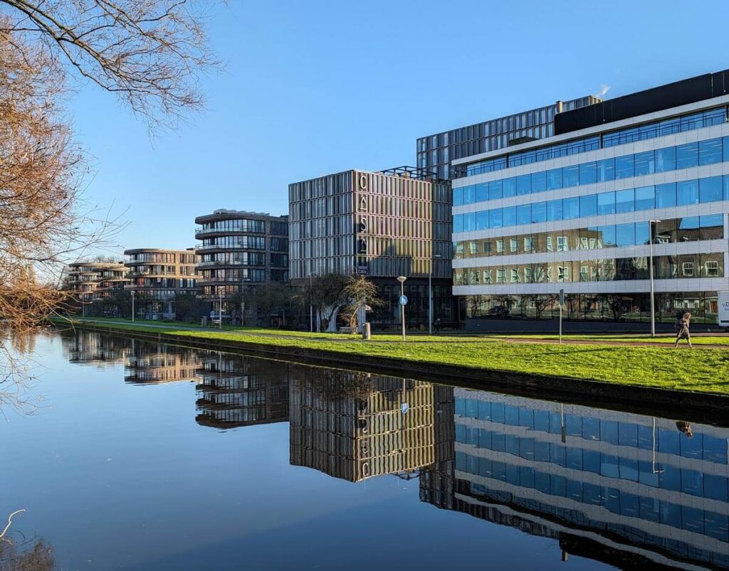 Hotel Casa and other buildings along a calm canal in Amsterdam