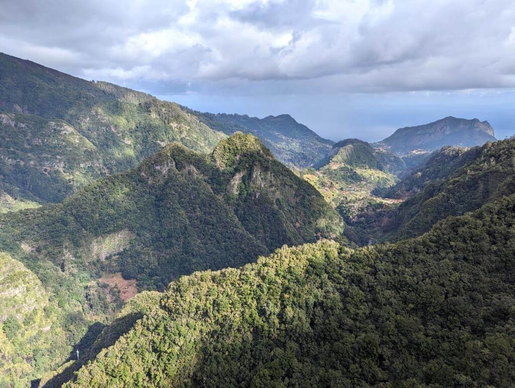 The view at the end of the Vereda dos Balcões walk. A wide, mountain view covered in trees and rocky peaks.