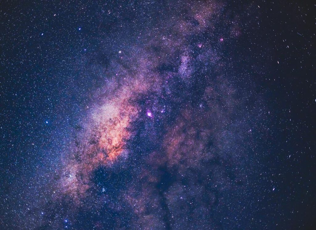 A colourful pink, purple and blue view of the Milky Way above Mount Bromo, Indonesia, one of the best places to go stargazing in Asia.