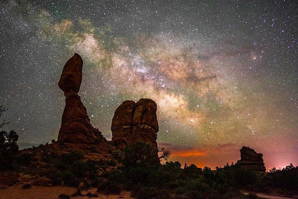 The Balanced Rock rock formation at Arches National Park with the Milky Way in the sky beyond