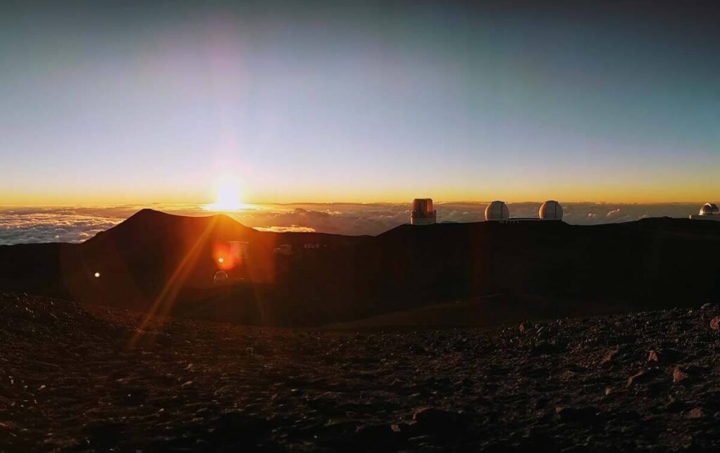 The observatories at Mauna Kea at sunset, high above the clouds