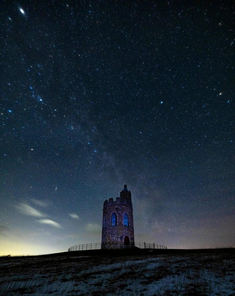 A starry night above the stone Hurlestone Tower in Northumberland