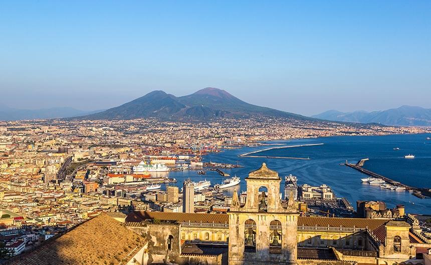 A view of Naples from above, with Mount Vesuvius in the background.