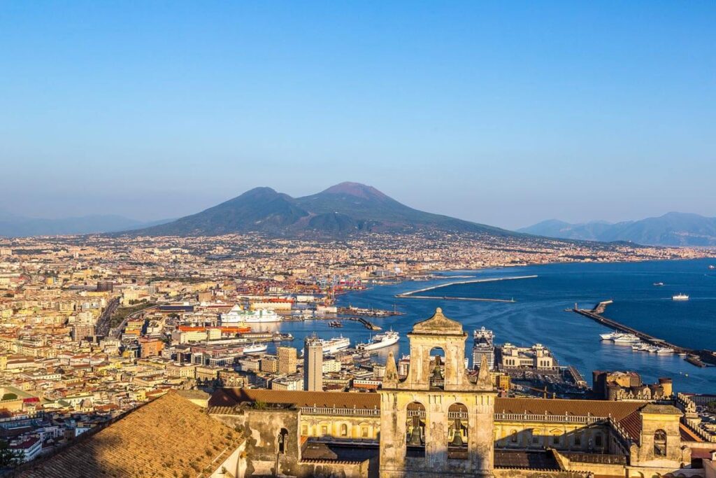 A view of Naples from above, with Mount Vesuvius in the background.