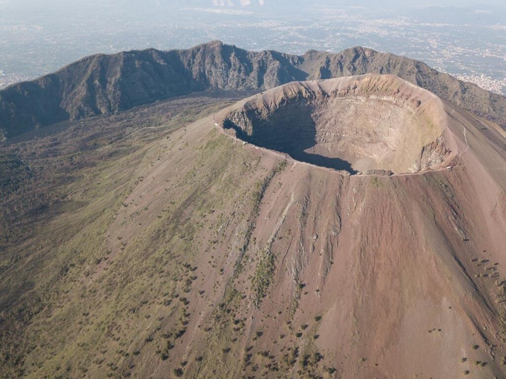 An aerial photo of the Great Cone of Mount Vesuvius, with the crater at the top