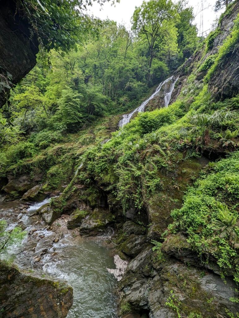 A wide waterfall flowing down a rocky slope