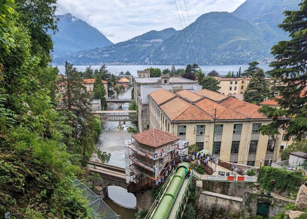 Looking down at the entrance to the Orrido di Bellano and the five-sided Ca' del Diavol tower, with the village of Bellano and Lake Como beyond