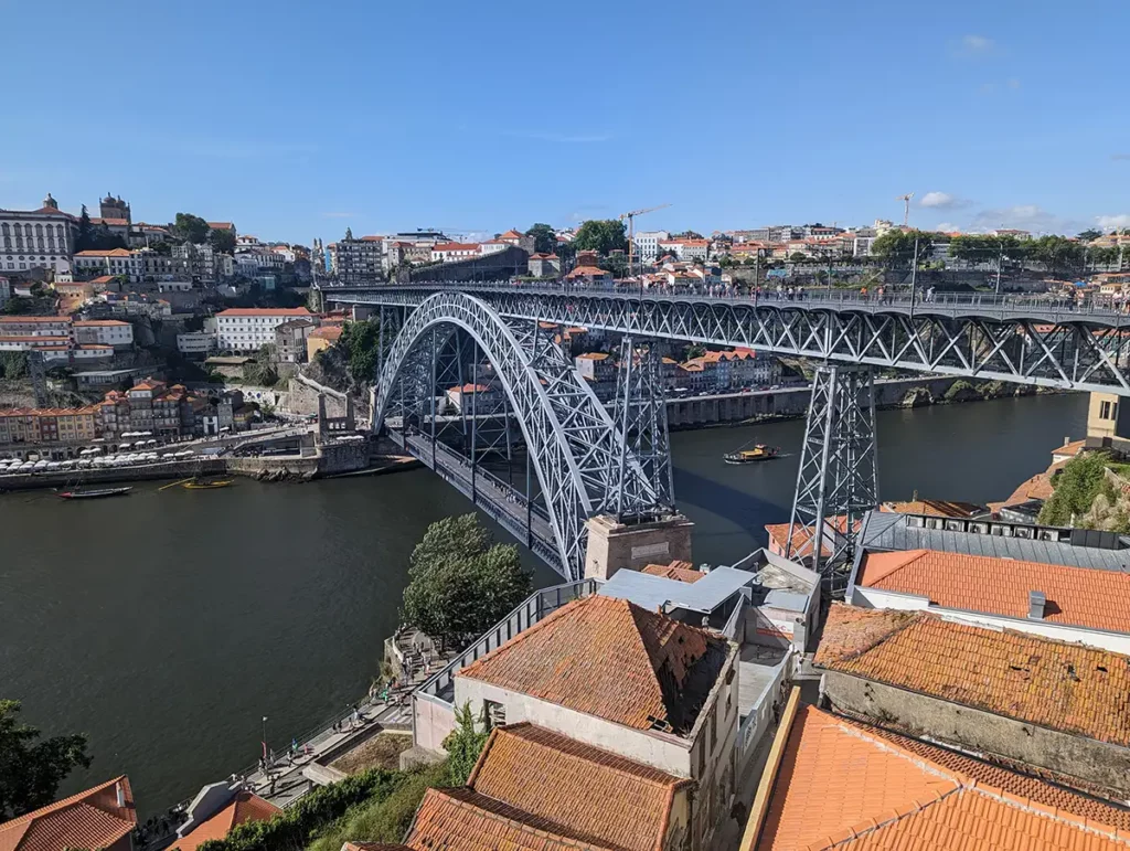 A beautiful metal bridge between two riverbanks in a historic city