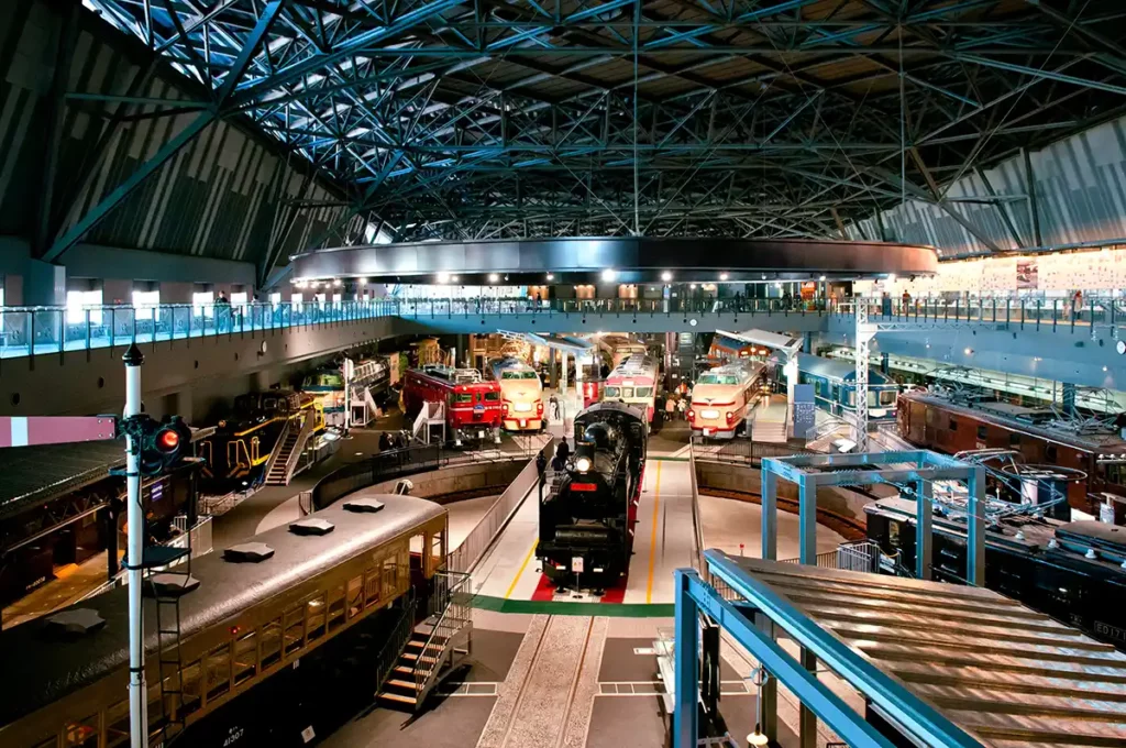 A railway museum with historic locomotives around a central turntable