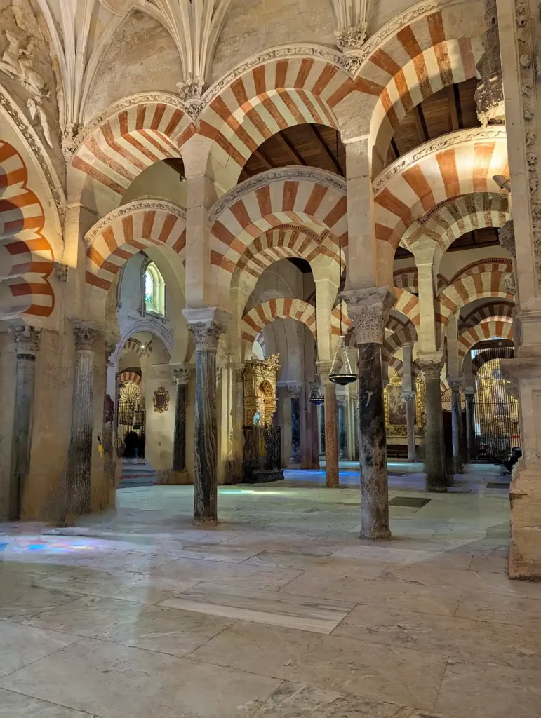 A forest of red and white striped arches in the Mezquita-Cathedral in Córdoba.